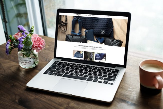 Laptop on a wooden table lifeline for equine businesses is a well ranked equine website